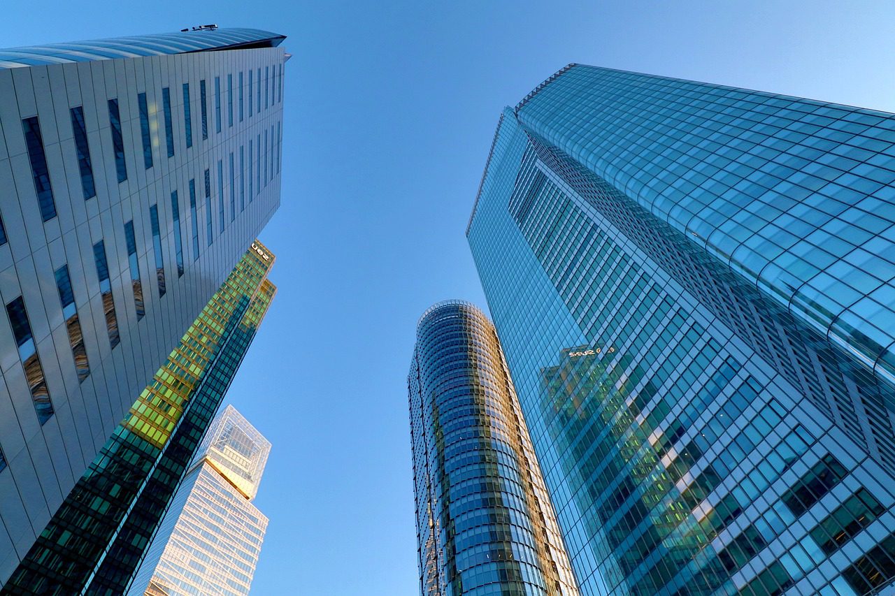 A view of some skyscrapers from below.