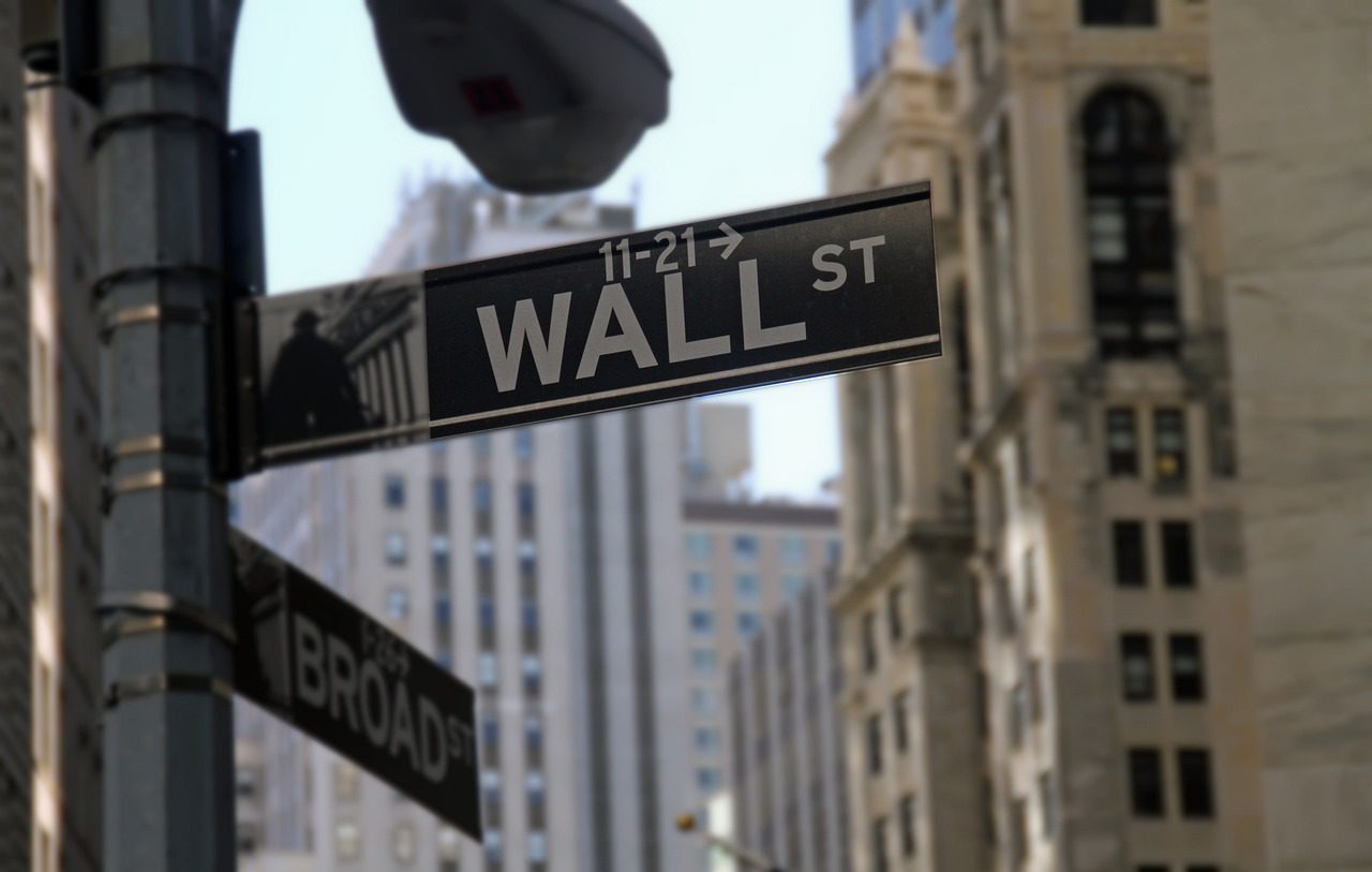 A street sign on the corner of wall st.